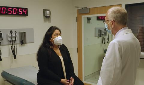 An MGNet researcher guides a patient through an exam