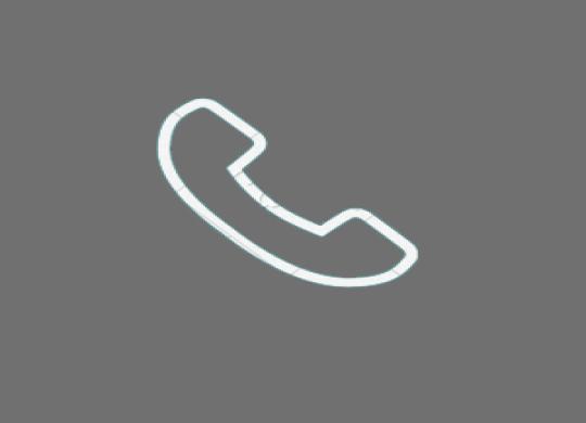 A white telephone against a gray background